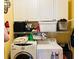 Functional laundry room with washer, dryer, shelving, and plenty of storage space for supplies at 272 Lynshire Sw Ct, Marietta, GA 30064
