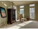 Sunlit living room boasts neutral carpet and paint, decorative cabinet, and large windows at 272 Lynshire Sw Ct, Marietta, GA 30064