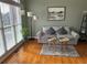 Cozy living room featuring hardwood floors, a comfortable gray sofa, and natural light from large windows at 272 Lynshire Sw Ct, Marietta, GA 30064