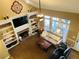 Open living area featuring built-in shelving, fireplace, ceiling fan, and access to an outdoor space at 272 Lynshire Sw Ct, Marietta, GA 30064