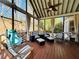 Relaxing screened porch with comfortable seating, ceiling fan, and views of the surrounding landscape at 272 Lynshire Sw Ct, Marietta, GA 30064