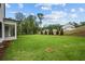 Expansive backyard featuring lush green grass and beautiful landscaping, perfect for outdoor activities and relaxation at 444 Lower Shoreline Ct Sw, Marietta, GA 30064