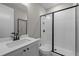 Modern bathroom featuring a walk-in shower with a black framed glass door and a sleek vanity with modern fixtures at 444 Lower Shoreline Ct Sw, Marietta, GA 30064