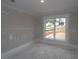 Cozy bedroom featuring a large window with views of the landscaped yard, showcasing natural light and a serene atmosphere at 444 Lower Shoreline Ct Sw, Marietta, GA 30064