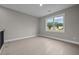 Minimalist bedroom with a large window offering neighborhood views, complemented by sleek wood floors and neutral walls at 444 Lower Shoreline Ct Sw, Marietta, GA 30064