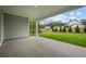 View of the covered patio and backyard offering a serene view of the surrounding greenery and neighboring homes at 444 Lower Shoreline Ct Sw, Marietta, GA 30064