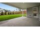View of the covered patio with a concrete floor, leading out to a well-maintained lawn and landscaping at 444 Lower Shoreline Ct Sw, Marietta, GA 30064