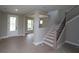 Open entryway with natural light, a staircase with dark metal railings and beautiful light wood floors at 444 Lower Shoreline Ct Sw, Marietta, GA 30064