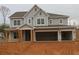 Charming two-story home featuring a three-car garage, a covered front porch, and modern farmhouse-style architecture at 444 Lower Shoreline Ct Sw, Marietta, GA 30064