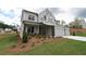 Charming two-story home featuring a three-car garage and lush front yard landscaping at 444 Lower Shoreline Ct Sw, Marietta, GA 30064