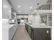 Bright kitchen featuring a large island, modern appliances, sleek white cabinets and stylish pendant lighting at 444 Lower Shoreline Ct Sw, Marietta, GA 30064