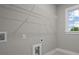Bright laundry room with window and storage rack at 444 Lower Shoreline Ct Sw, Marietta, GA 30064