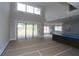 Bright living room with high ceilings, large windows, and sliding glass doors at 444 Lower Shoreline Ct Sw, Marietta, GA 30064