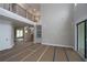 Spacious living room with soaring ceilings, a balcony overlook, and sliding glass doors, providing a grand and airy living space at 444 Lower Shoreline Ct Sw, Marietta, GA 30064