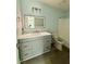Bathroom with gray vanity, large mirror, white countertops, and a tub with shower at 5075 Forest Downs Ln, Atlanta, GA 30349