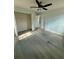 Bright bedroom featuring modern floors, neutral paint, and closet at 5075 Forest Downs Ln, Atlanta, GA 30349