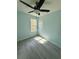 Bedroom with wood-look flooring, ceiling fan, and natural light at 5075 Forest Downs Ln, Atlanta, GA 30349