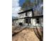 Home exterior showing a white siding, black trim, and gravel landscaping at 5075 Forest Downs Ln, Atlanta, GA 30349