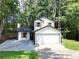 Charming two-story home features a classic design and a two-car garage at 5075 Forest Downs Ln, Atlanta, GA 30349