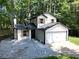 Charming two-story home features a classic design and a two-car garage at 5075 Forest Downs Ln, Atlanta, GA 30349