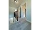 Second floor hallway with wood railing and light blue walls at 5075 Forest Downs Ln, Atlanta, GA 30349