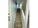 Carpeted stairs leading to the second floor with a railing at 5075 Forest Downs Ln, Atlanta, GA 30349