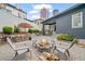 Charming backyard featuring a fire pit area with chairs and professional landscaping at 6845 Wesley Hughes Rd, Cumming, GA 30040