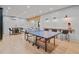 Finished basement with a ping pong table, bar, and entertainment area at 6845 Wesley Hughes Rd, Cumming, GA 30040
