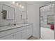 Bright bathroom showcasing double sinks, marble countertops, and views to the bedroom for a luxurious feel at 6845 Wesley Hughes Rd, Cumming, GA 30040