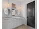 Bright bathroom features a marble double sink vanity and stylish decorative lighting at 6845 Wesley Hughes Rd, Cumming, GA 30040