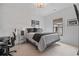 Modern bedroom features a work space, window with blind, and neutral decor at 6845 Wesley Hughes Rd, Cumming, GA 30040