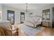 Bright bedroom featuring hardwood floors, natural light, neutral decor, and a cozy ambiance at 6845 Wesley Hughes Rd, Cumming, GA 30040