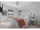 Bright bedroom features a neutral decor, plush carpet, a TV, and a large window at 6845 Wesley Hughes Rd, Cumming, GA 30040