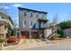 Stunning three-story home featuring a two-car garage and beautiful landscaping at 6845 Wesley Hughes Rd, Cumming, GA 30040