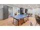Game room with ping pong table, bar area, kitchenette, and hardwood flooring at 6845 Wesley Hughes Rd, Cumming, GA 30040