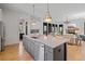 Bright and modern kitchen with center island, stainless steel appliances, and open layout at 6845 Wesley Hughes Rd, Cumming, GA 30040