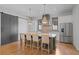 Open kitchen with a large island, stainless steel appliances, pendant lighting, and modern cabinetry at 6845 Wesley Hughes Rd, Cumming, GA 30040