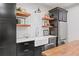 Close-up of the kitchenette with floating wood shelves and sleek white countertops at 6845 Wesley Hughes Rd, Cumming, GA 30040