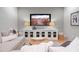 Comfortable living room features a large screen TV, a console, modern lamps, and plush seating, perfect for relaxation at 6845 Wesley Hughes Rd, Cumming, GA 30040