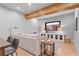 Cozy living area with hardwood floors, a comfortable sofa, and a large screen television at 6845 Wesley Hughes Rd, Cumming, GA 30040