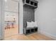 Functional mudroom with gray storage unit, hooks, and a view into the adjacent game room at 6845 Wesley Hughes Rd, Cumming, GA 30040