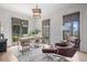 Bright home office with natural light, a wooden desk, comfortable seating, and a serene outdoor view at 6845 Wesley Hughes Rd, Cumming, GA 30040