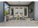 Relaxing covered patio includes a seating area, outdoor heater, and a view of the landscaped backyard at 6845 Wesley Hughes Rd, Cumming, GA 30040