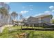 View of the house from the backyard, showcasing the deck and landscaped lawn at 9991 Holly Hill Way, Jonesboro, GA 30238