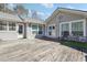 Backyard deck featuring light gray siding, lots of windows and a seating area at 9991 Holly Hill Way, Jonesboro, GA 30238