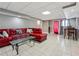 Finished basement with a large red sectional sofa, a glass coffee table, and tile flooring at 9991 Holly Hill Way, Jonesboro, GA 30238