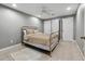 Bedroom with neutral walls, tile floors, a white ceiling fan, and a decorative bed frame at 9991 Holly Hill Way, Jonesboro, GA 30238