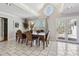 Bright dining area with large windows, a round window, tile flooring, and access to the deck at 9991 Holly Hill Way, Jonesboro, GA 30238