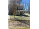 View of the exterior of the home with a white picket fence and a well-maintained lawn at 9991 Holly Hill Way, Jonesboro, GA 30238