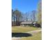Ranch-style home with a long porch, surrounded by a well-maintained lawn and mature trees at 9991 Holly Hill Way, Jonesboro, GA 30238